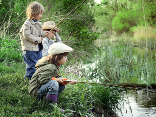 happy boys go fishing on the river